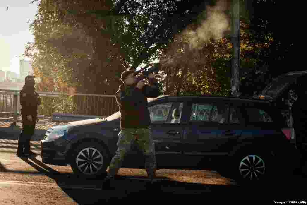 A police officer fires at a drone.&nbsp;