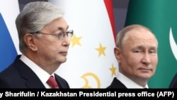 Kazakh President Qasym-Zhomart Toqaev poses with Russian President Vladimir Putin in Astana on October 14, 2022.