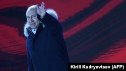 RUSSIA -- Presidential candidate, President Vladimir Putin waves as he addresses the crowd during a rally and a concert celebrating the fourth anniversary of Russia's annexation of Crimea on Manezhnaya Square in Moscow, March 18, 2018