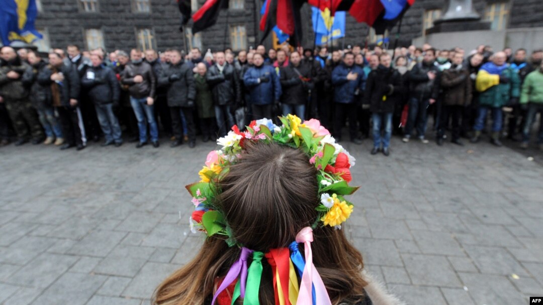 Pro-European demonstrators block the entrance to a government building in Kyiv on December 5.