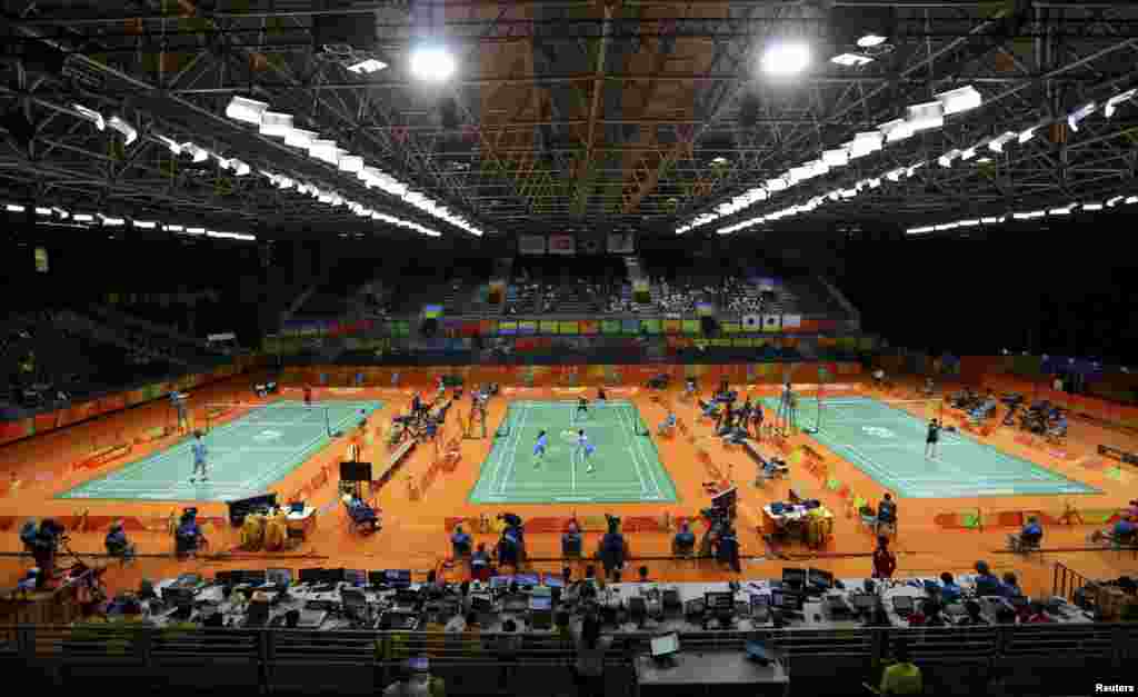 General overview of venue as three badminton matches go on simultaneously.