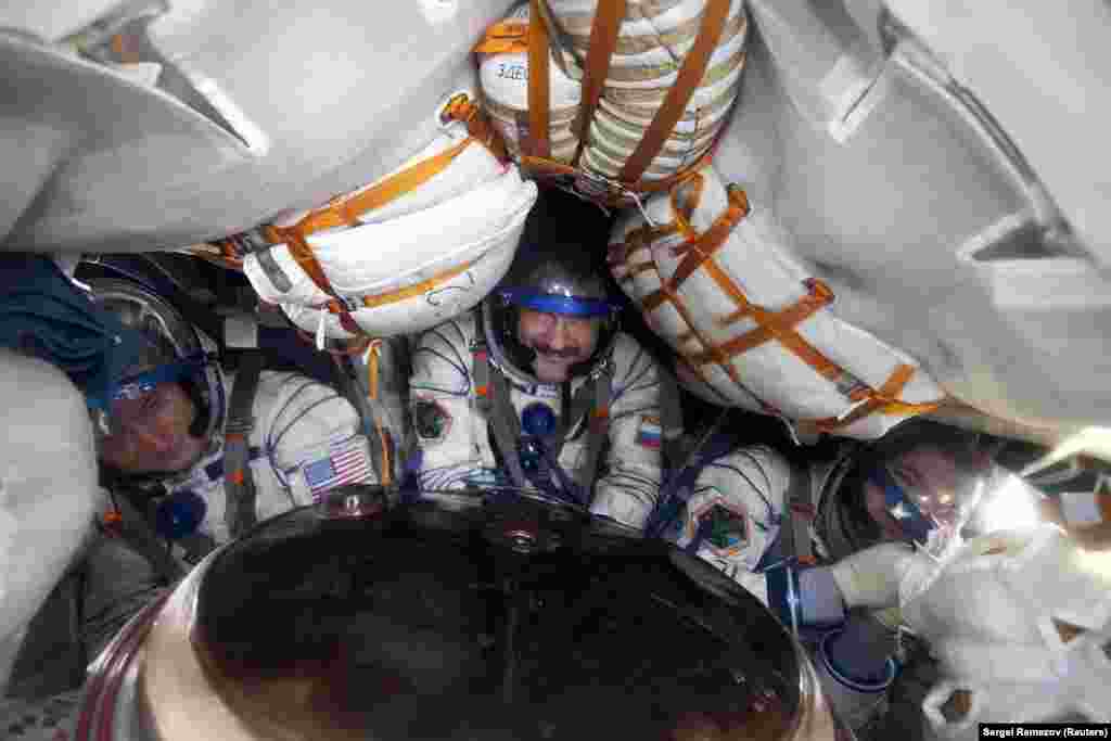 U.S. astronaut Scott Kelly sits with Russian cosmonauts Aleksandr Kaleri and Oleg Skripochka in the Soyuz landing capsule in 2011. While highly reliable, the Soyuz rockets launched from Baikonur are famously uncomfortable and too cramped to fit a toilet. Space travelers must wear diapers for the two-day journey to the ISS.