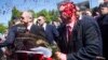 Russia's ambassador to Poland, Sergei Andreyev (right), was doused with red paint by participants of a protest against Russia's invasion of Ukraine during his attempt to lay flowers at a cemetery in Warsaw on May 9.