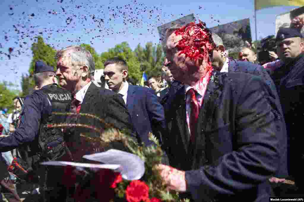 Russia&#39;s ambassador to Poland, Sergei Andreyev (right), was doused with red paint by participants of a protest against Russia&#39;s invasion of Ukraine during his attempt to lay flowers at a cemetery in Warsaw on May 9.