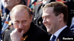 Dmitry Medvedev (right), president at the time, and then-Prime Minister Vladimir Putin enjoy a Victory Day military parade on Moscow's Red Square in 2008.