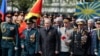 Russian President Vladimir Putin (center) attends a wreath-laying ceremony at the Tomb of the Unknown Soldier on Victory Day in central Moscow on May 9.