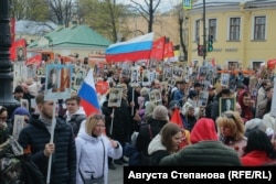 Emberek a Halhatatlan Ezred-felvonuláson Szentpéterváron 2022. május 9-én