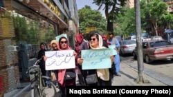 Afghan women protest against a Taliban decree on the compulsory hijab in Kabul on May 10. The Amnesty report documents how women who peacefully protest have been threatened, arrested, detained, tortured, and forcibly disappeared.
