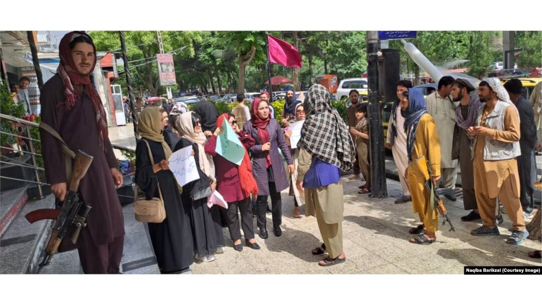 Afghan women protest the Taliban leader’s decree requiring them to cover their faces in public.