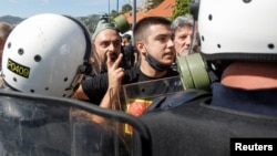 Demonstrators argue with police during a protest against the enthronement of Bishop Joanikije II in Cetinje, Montenegro, on September 4.