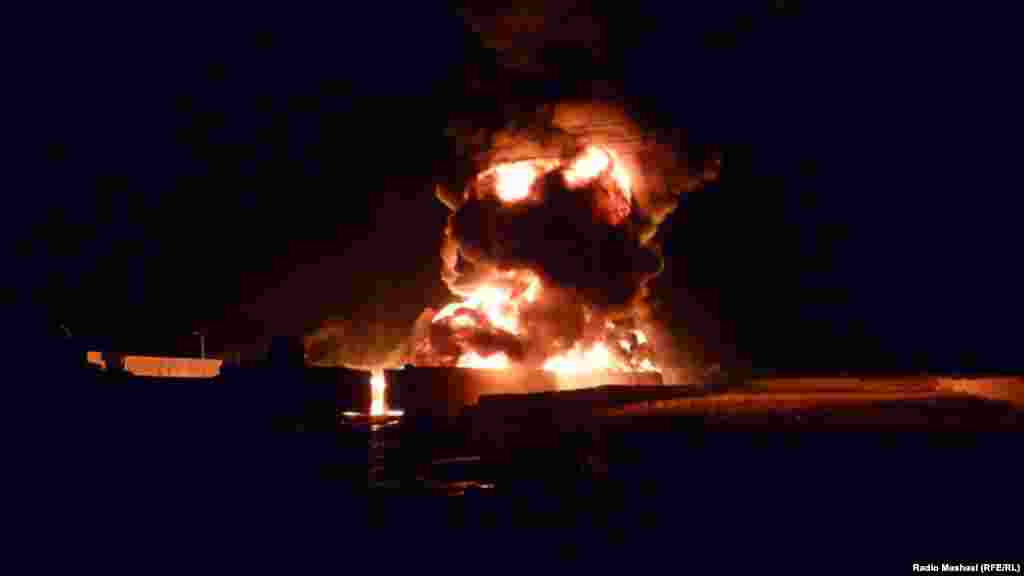 NATO oil tankers and goods trucks are set ablaze during an attack by gunmen in Quetta, Pakistan, on December 8. (Photo by RFE/RL's Radio Mashaal)