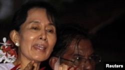 Aung San Suu Kyi speaks with supporters after her release from house arrest in Yangon on November 13.