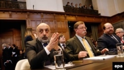 Russian representative Roman Kolodkin (left) and others sit at The International Court of Justice in The Hague last month. 