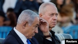 Israeli Prime Minister Benjamin Netanyahu (left) and Defense Minister Yoav Gallant attend a military ceremony at an army base on October 31.