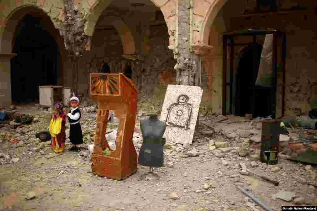 Boys visit the burnt-out main church as Iraqis attend the first Palm Sunday procession in the Christian city of Qaraqosh on April 9 since Iraqi forces retook it from Islamic State militants. (Reuters/Suhaib Salem)