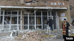 A priest stands in front of a hospital destroyed after shelling between Ukrainian forces and pro-Russian separatists in the eastern city of Donetsk, Ukraine, on January 19. 
