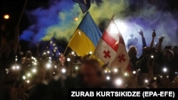 People attend a "March for Europe" rally in support of Georgia and Ukraine's EU membership bids in Tbilisi on June 24.