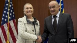 Bosnian Prime Minister Vjekoslav Bevanda (right) greets U.S. Secretary of State Hillary Clinton at the U.S. Embassy in Sarajevo.