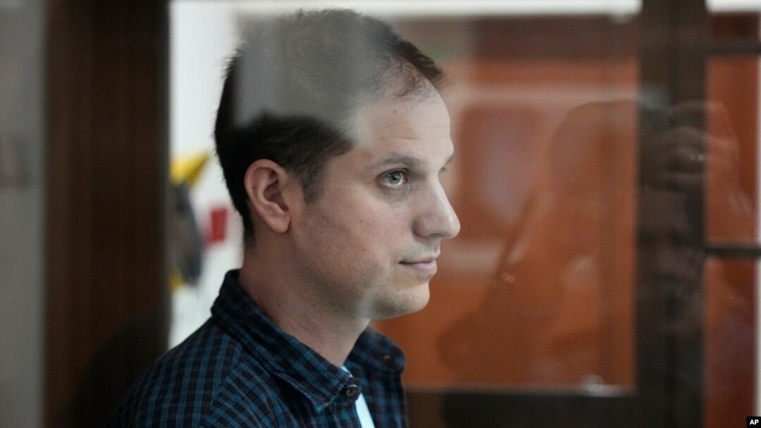 Evan Gershkovich stands in a glass enclosure during a court hearing in Moscow in October.