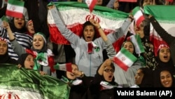 Iranian women cheer after authorities in a rare move allowed some women into the Azadi stadium to watch a soccer match in October 2018.