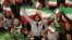 Iranian women cheer as they wave their country's flag after the authorities allowed a select group of women into Azadi Stadium to watch a friendly soccer match between Iran and Bolivia in Tehran on October 16, 2018.