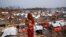 BANGLADESH-ROHINGYA/FIRE/ A Rohingya refugee woman carries her child as she looks on in a refugee camp after a massive fire broke out two days ago in Cox's Bazar, Bangladesh, March 24, 2021. 