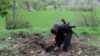 A Kurdish PJAK (Free Life Party of Kurdistan) rebel inspects an alleged Iranian artillery crater near Qandil, in Iraq, in April 2008.