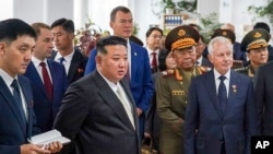 North Korean leader Kim Jong Un (center left) visits a Russian aircraft plant that builds fighter jets in Komsomolsk-on-Amur, Russia, on September 15.