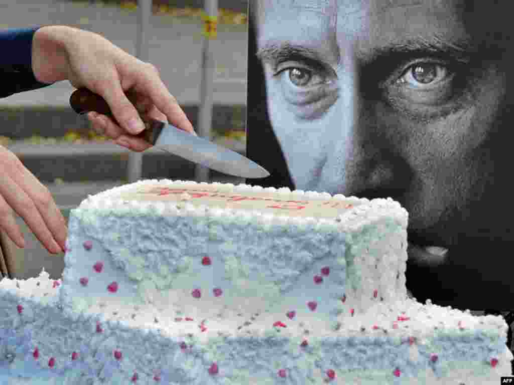 An activist of Putin's Army cuts a birthday cake in central Moscowon October 7. (Photo by Aleksandr Nemenov for AFP)