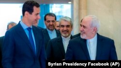 Сирия басшысы Башар Асад (сол жақта) және Иран сыртқы істер министрі Мохаммад Зариф. Дамаскі, 16 сәуір 2019 жыл.