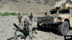 Afghan border policemen take their positions after overnight clashes with Pakistani forces on the border between Afghanistan and Pakistan in the eastern Afghan province of Nangarhar on June 13.