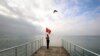 A man holds a Soviet flag as he stands on a pier during the opening of the cold-water swimming season in the Black Sea town of Saky, Crimea, on November 24. (Reuters/Pavel Rebrov)