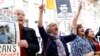 Supporters of the MKO protest outside Stockholm District Court at the start of Hamid Nouri's trial in Stockholm on August 10, 2021.