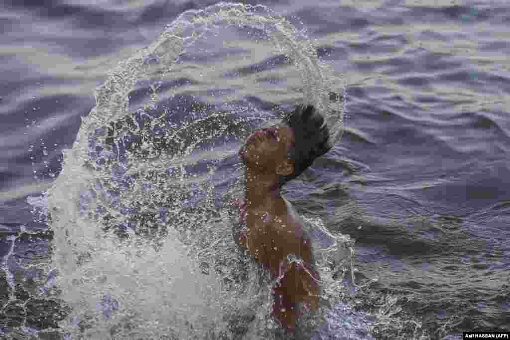 A Pakistani youth cools off in the Arabian Sea on a hot summer afternoon in Karachi.&nbsp;