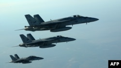 US Navy F-18E Super Hornets in flight on September 23, 2014. These aircraft were part of a large coalition strike package that was the first to strike IS targets in Syria.