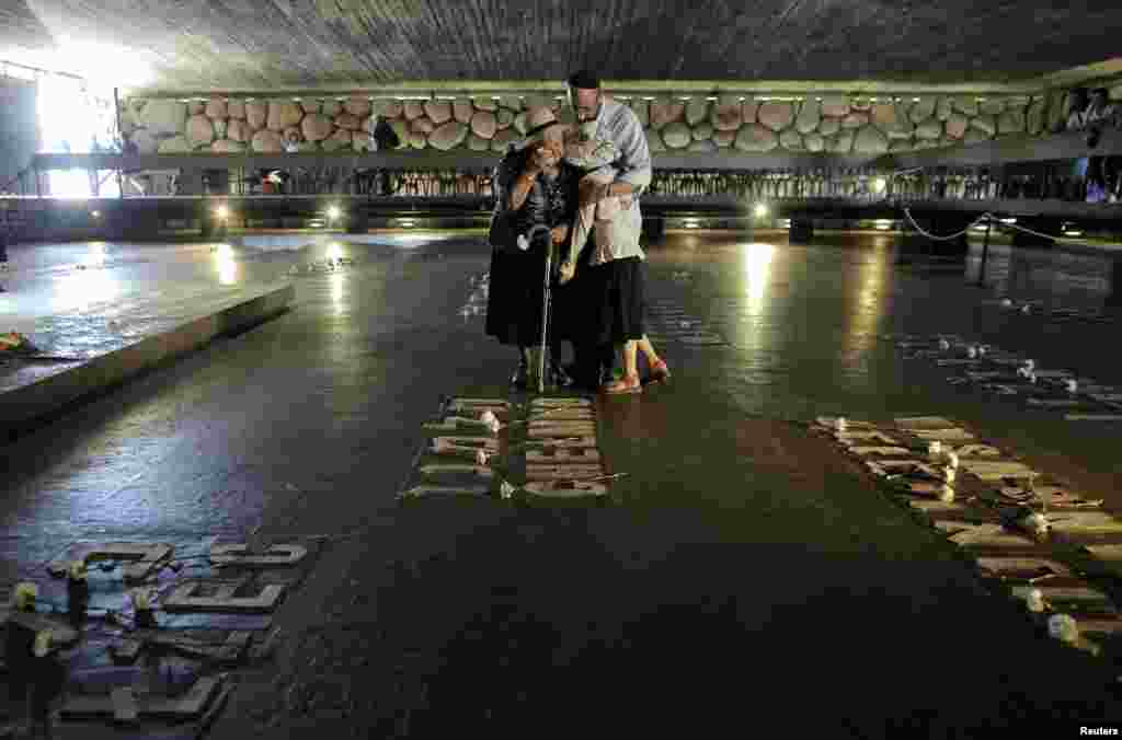 An Israeli woman is comforted as she cries in the Hall of Remembrance during a ceremony entitled &quot;Unto Every Person There Is A Name,&quot; marking Holocaust Remembrance Day at Yad Vashem in Jerusalem on April 28. (Reuters/Ammar Awad)