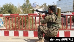 An Afghan army soldier taking aim at insurgents inside Kunduz city.