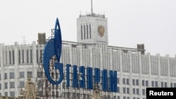 Russia -- The company logo of natural gas producer Gazprom is seen on an advertisement in front of the White House in Moscow, 08Feb2013