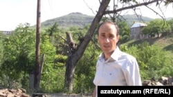 Armenia - RFE/RL correspondent Hovannes Shoghikian reports from Chinari against the backdrop of an Azerbaijani army post overlooking the Armenian border village, 8Jun2012.
