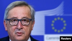 European Commission President Jean Claude Juncker says he is visiting Russia next month for dialogue, not to weaken sanctions.