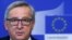 European Commission President Jean Claude Juncker says he is visiting Russia next month for dialogue, not to weaken sanctions.
