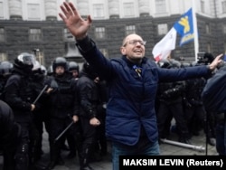 Yatsenyuk, then a Ukrainian opposition leader, reacts as protesters clash with riot police during a rally to support EU integration in central Kyiv on November 24, 2013.
