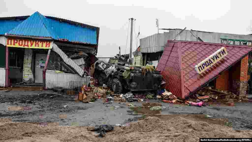 A destroyed Russian armored personnel carrier stands amid the ruins of a commercial area in the village of Nova Basan in the Chernihiv region on April 1.