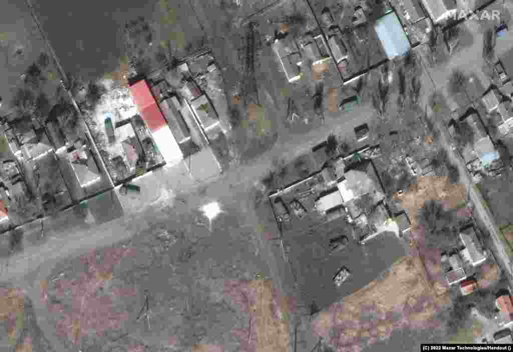 Maxar says the satellite images show Russian tanks and armor deployed around homes.