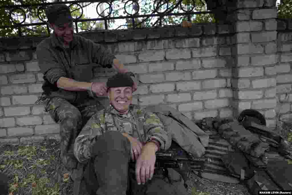 Ukrainian Army soldiers from the Aydar Battalion joke as they rest in the village of Schastya, near the eastern Ukrainian city of Luhansk, on September 22, 2014.