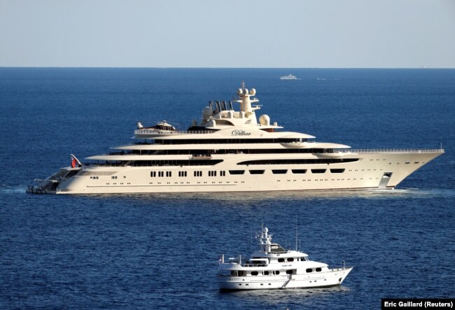 The 156-meter-long Dilbar, seen here off the cost of Monaco in 2017, is estimated to be worth $594 million, according to the Bloomberg Billionaires Index. Owned by Russian billionaire Alisher Usmanov, it cannot leave the port of Hamburg. Initial reports said it was seized, but others say sanctions prevent the paying of the crew and German authorities have not issued a customs document allowing for its departure. With holdings in mining, media, and telecoms, Usmanov is seen as closely linked to President Putin. Usmanov issued a statement on March 1&nbsp;saying that the sanctions were based on &quot;false and defamatory allegations damaging my honor, dignity, and business reputation. I will use all legal means to protect my honor and reputation.&quot;