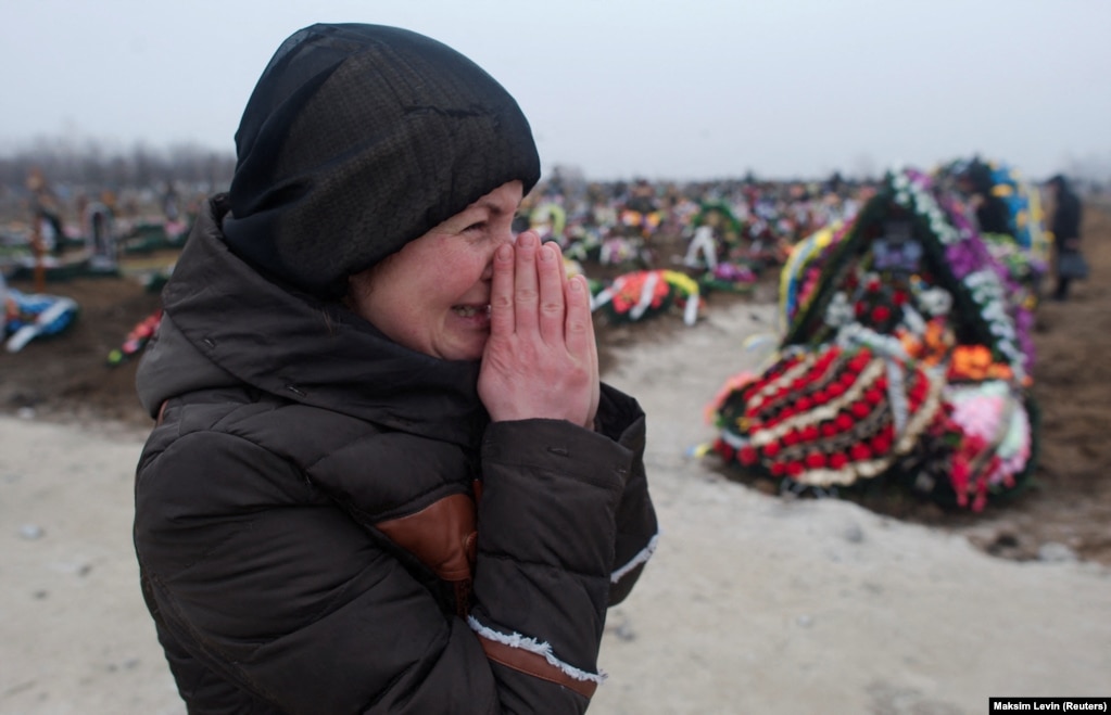 Një familjare e një viktime të granatimeve nga separatistët e mbështetur nga Rusia duke qarë pranë një varreze, në Mariupol, Ukrainë, më 27 janar 2015.