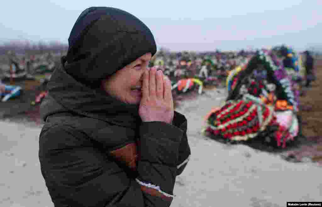 A relative of a victim of shelling by Russia-backed separatists sheds tears at a cemetery in Mariupol, Ukraine, on January 27, 2015.