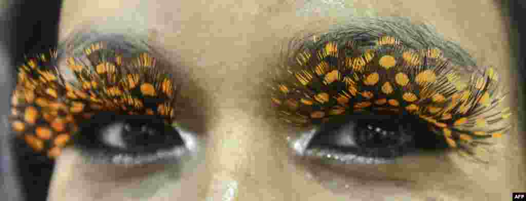 A visitor displays glue-on eyelashes during the BeautyAsia show in Singapore. The three-day event showcases the latest innovations and trends in the beauty industry. (AFP/Roslan Rahman)