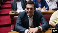 Greek Prime Minister Alexis Tsipras looks on during the Syriza party's parliamentary group meeting at the Greek parliament in Athens on July 15.